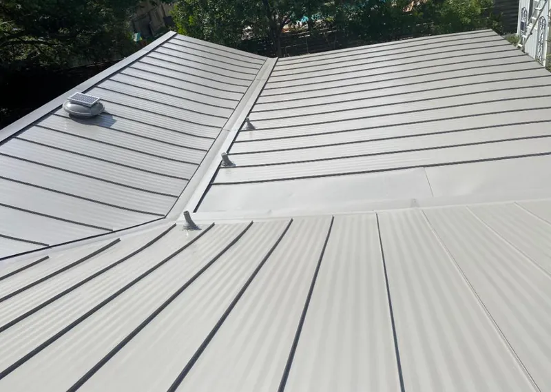Solar attic fan installed on a metal roof for Roof Ventilation in Yonkers